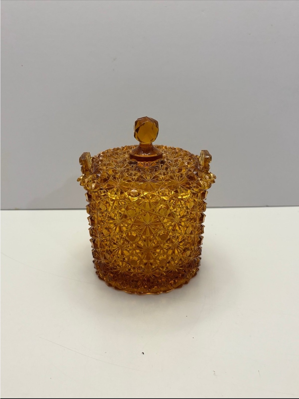 vintage amber glass covered candy dish in Daisy and Button pattern